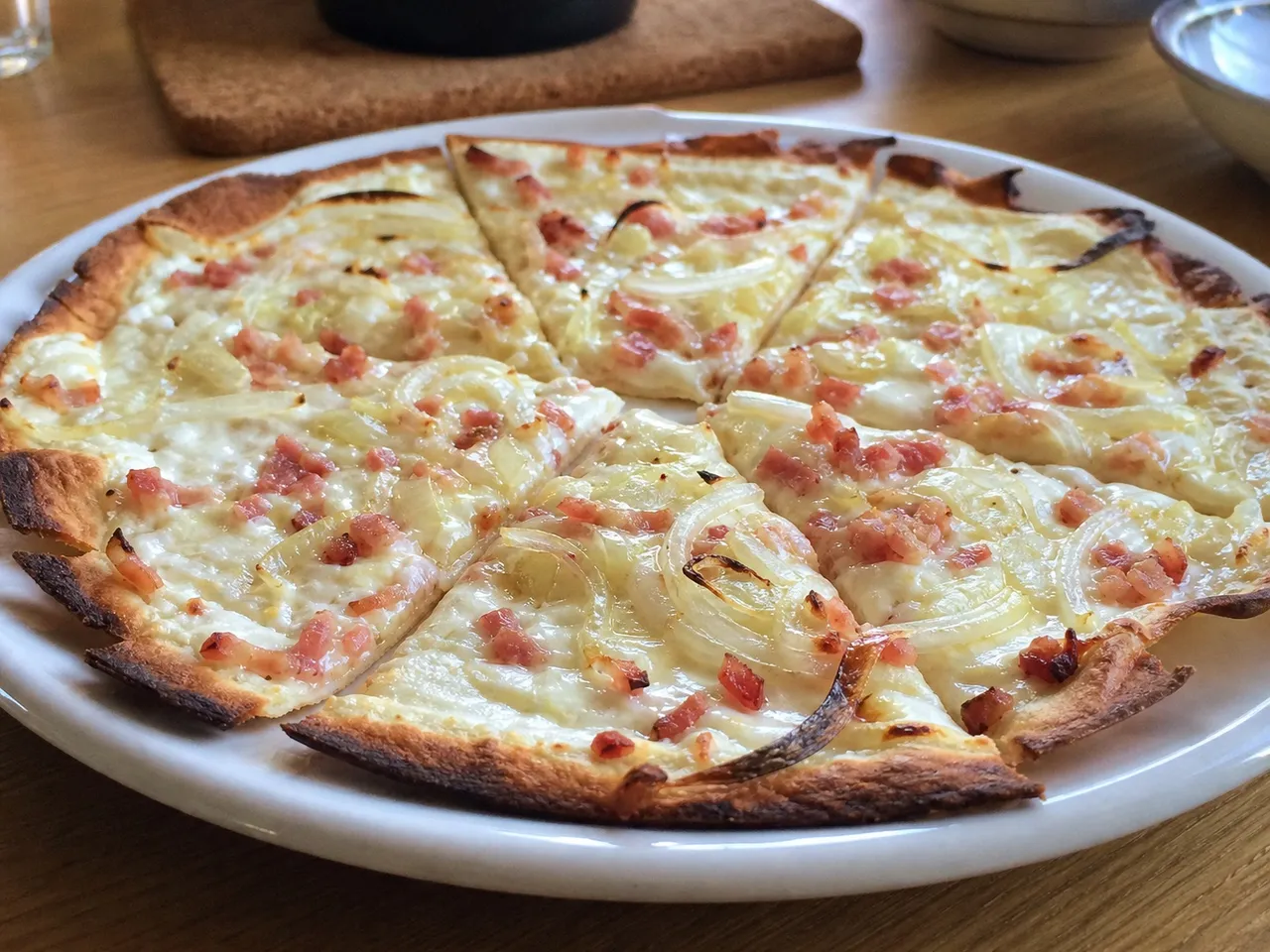 Flammkuchen (German Flatbread with Bacon and Onion) — served