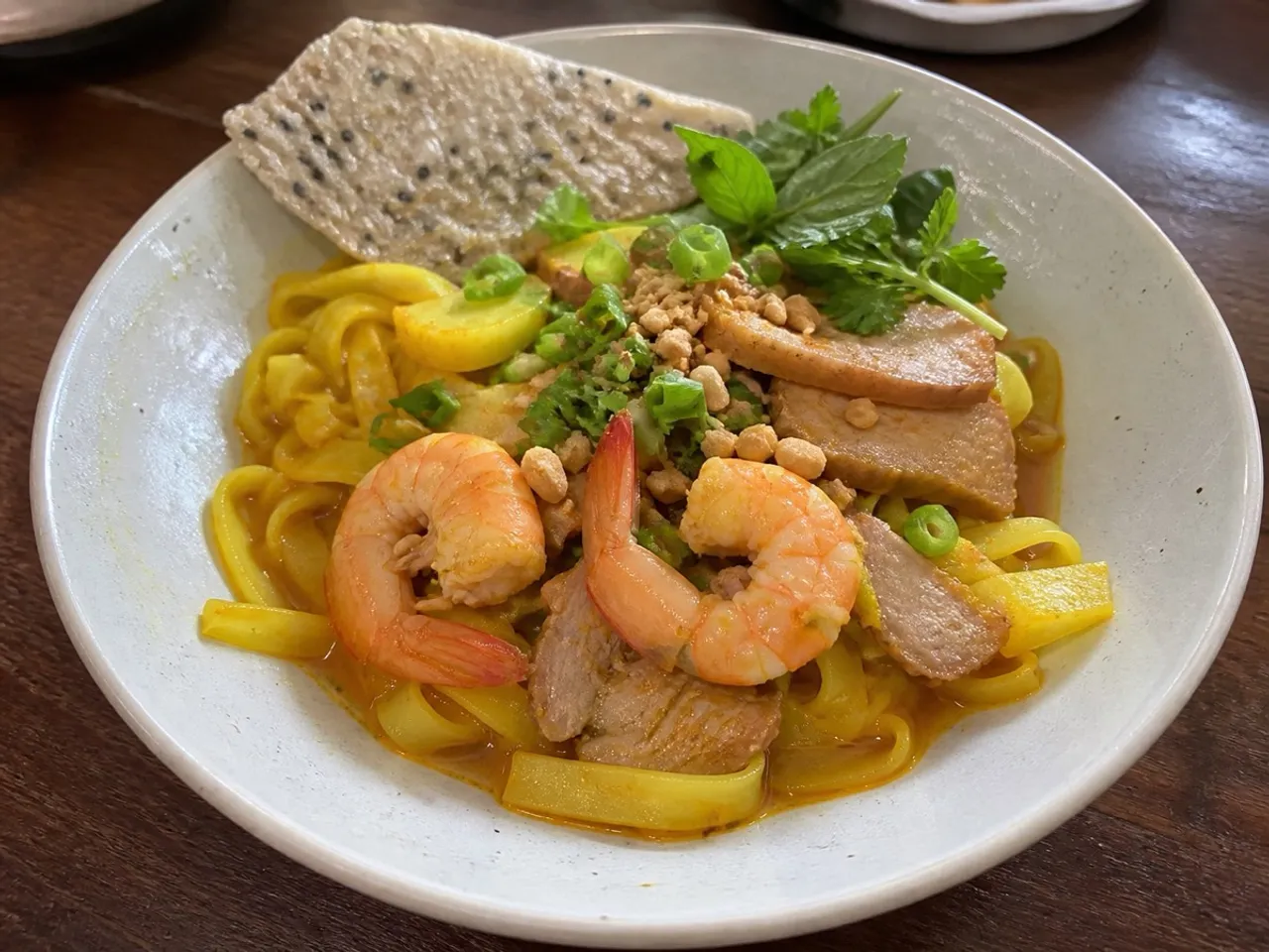 Mì Quảng (Turmeric Noodle Soup) — served