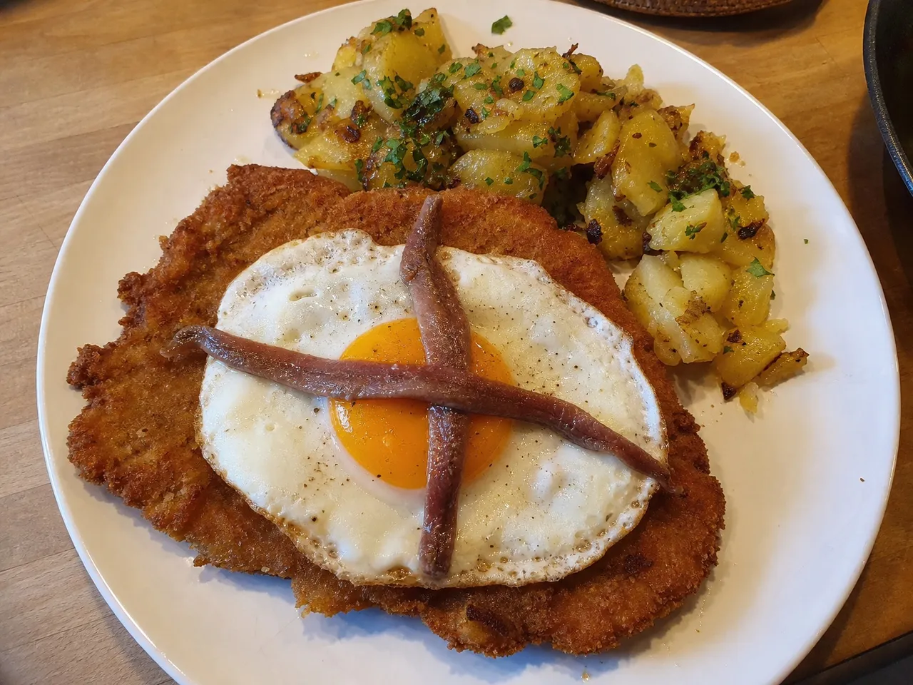 Schnitzel Holstein (with Fried Egg and Anchovies) — served